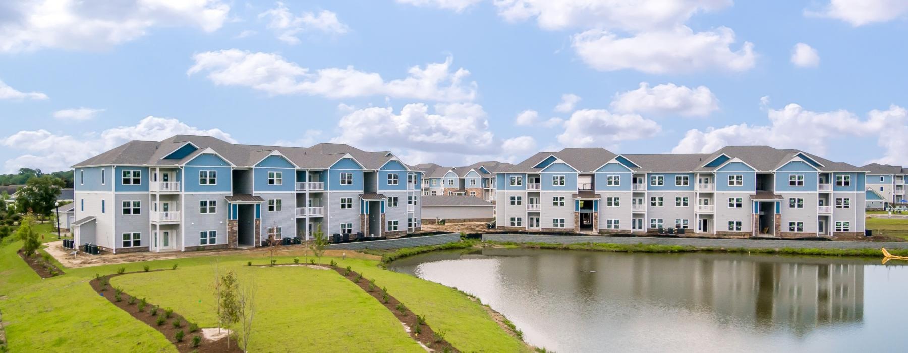 a row of houses next to a body of water