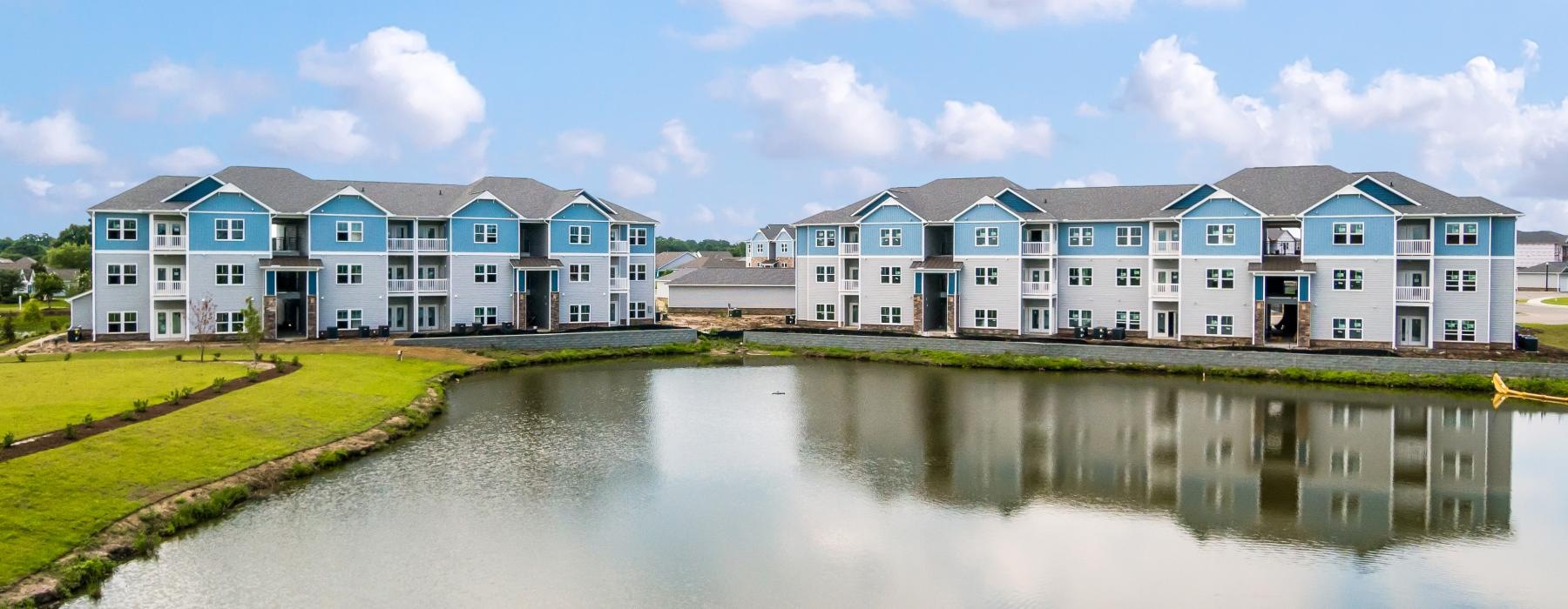 a row of buildings by a body of water