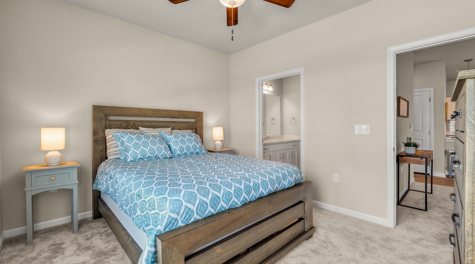 a bedroom with a bed and a fan